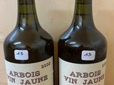 two bottles of wine sitting on top of a wooden table