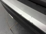a close up of a car ' s bumper with scratches on it