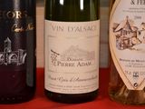 three bottles of wine are lined up on a table