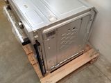 a metal box sitting on a pallet in a room