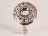 a silver plate with a clock on top of it