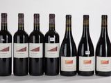 six bouteilles de vin rouge alignées sur une table