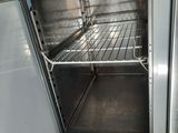 an open oven that is sitting on the floor