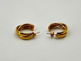 a pair of gold hoop earrings on a white background