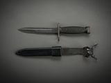 two knives that are laying side by side on a table