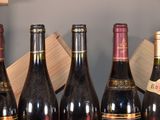 several bottles of wine are lined up in a row on a counter