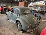 an old car that is sitting in a garage