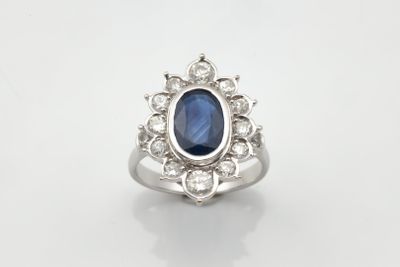 Bague marguerite centrée d’un saphir ovale dans un entourage…