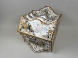 a decorative box with flowers on it sitting on a table