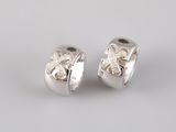 a pair of silver and diamond earrings on a white background