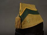 a hat with a tassel on top of it