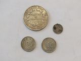 three coins are shown next to each other on a white surface