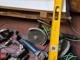 a yellow tape measure sitting on the floor next to a pile of tools