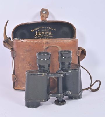 a brown leather case with a pair of binoculars in it