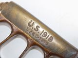 a close up of a metal object with a name on it