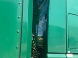 a green truck that is parked on the side of the road