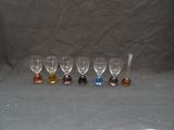 six verres à vin sont alignés sur un fond gris