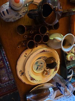 a table with a bunch of dishes and cups on it