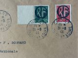 two stamps on a brown envelope with a red and green stamp