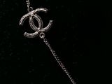 a close up of a chain with a chanel logo on it