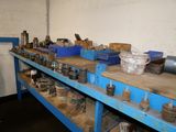 a blue workbench with many different types of tools on it