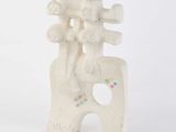 a white sculpture with a man on a horse on top of it