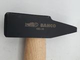 a hammer with a wooden handle on a white surface