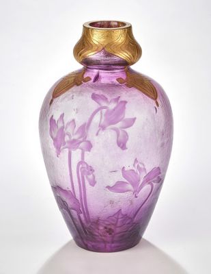 a purple glass vase with a gold rim on a white surface