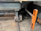 a machine that is working on a steel beam