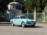 a blue car that is parked in front of a gate