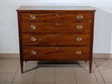 a wooden chest of drawers in a room with tile flooring