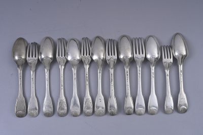 six spoons and six forks are lined up on a table