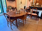 a table and chairs in a room with a fireplace