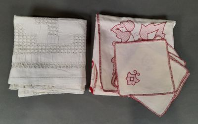 two white and red napkins with red embroidery on them