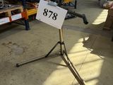 a sign on a tripod in a large warehouse