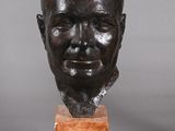 pair of bronze busts of a man and a woman on marble bases
