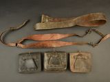three pieces of leather and a leather belt with metal buckles