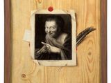 an old photo of a man with a feather in a wooden frame