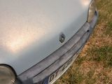 a car that is parked on the grass in front of a house