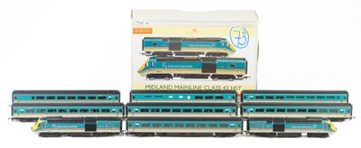 four blue and black train cars sitting next to each other