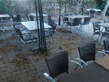 many tables and chairs that are outside on the patio