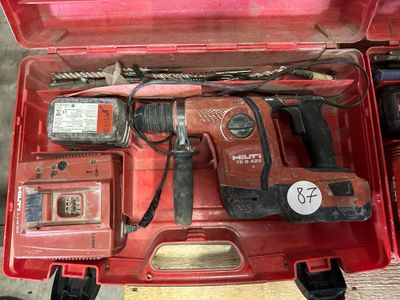a red tool box with tools in it on the floor