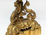 a gold plate with a bird on it on a stand