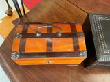 two boxes sitting on a table with a ring on top of them