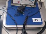 a laptop computer sitting on top of a blue and white table