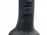 a black vase that is sitting on a white surface