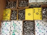 many boxes of screws in a box on the floor