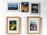 four framed photographs of different types of art hanging on a wall
