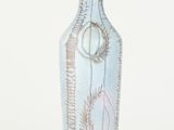 a blue vase with a design on it on a white background