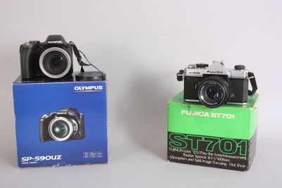 two cameras sitting next to each other on a table
